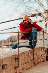 young latin man with smartphone in the city of lyon