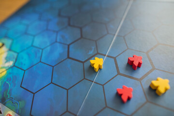 Board game concept. Figures, meeple, tiles and game table