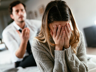 Husband and wife are arguing at home. Angry man is yelling at his wife..