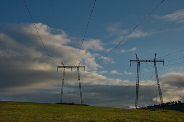 Russia. Republic of Khakassia. Illuminated by the morning sun, power transmission poles in the endless steppes.