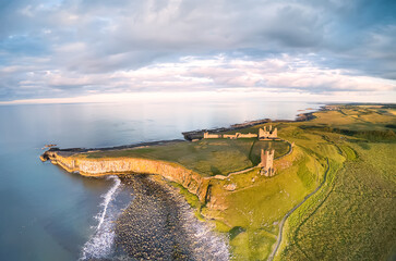 View from above on ruins of Dunstanburgh castle, Embleton bay, England. Northumberland, UK