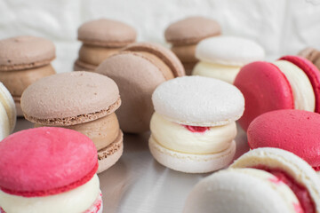 Colorful french macarons dessert. Set of various different tastes and color macaron cookies, with delicious cream ganache, on the table at pastry shop