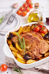 Turkey breast meat baked with potato wedges, red onion, tomatoes and rosemary. Healthy dinner for the family.
