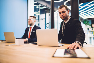 Serious businessmen using laptops in office