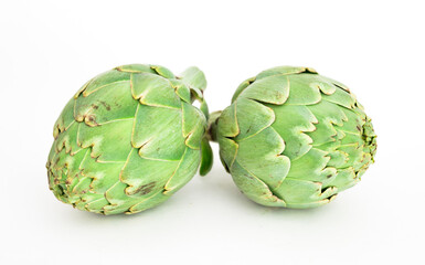 two ripe artichokes on white background
