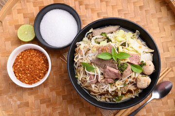 Rice noodle soup with pork, pork ball and vegetables in a bowl, Thai noodles soup
