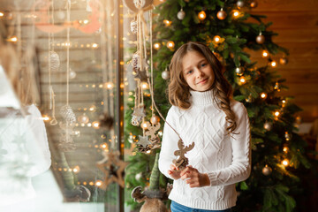 beautiful teenage girl at home near christmas tree 