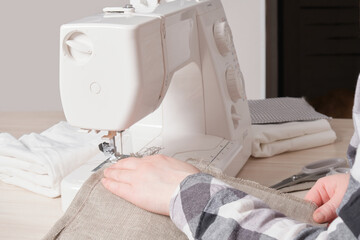 woman working with sewing machine, white sewing machine on table