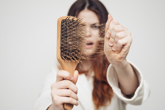 upset woman removes hair from comb health problems bun