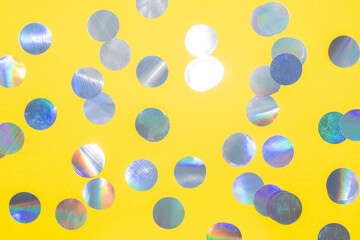 holographic round confetti pattern on a yellow background