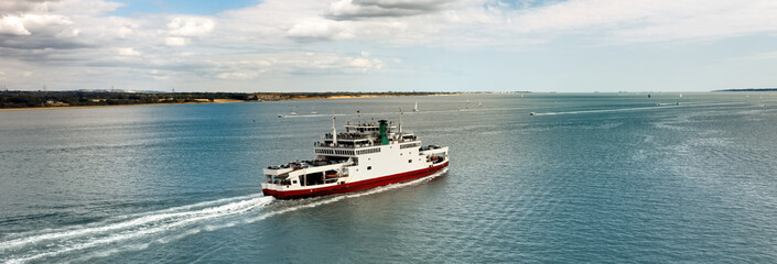 Banner - Car ferry in Southampton Water on a beautiful sunny day with clouds in the blue sky. With space for text. - 414689376