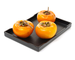 persimmon on a wooden plate