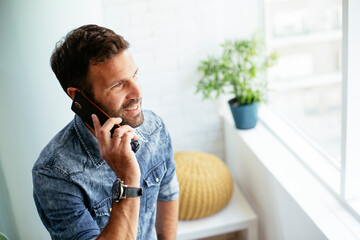 Businessman in office using the phone. Young businessman talking to the phone