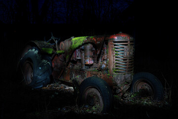 Old tractor abandoned in a forest