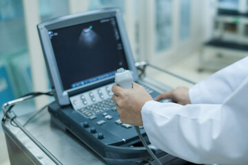 Physician making echocardiography for male patient heart, focus screen of echocardiography machine.