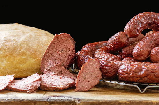 Homemade Venison Sausage On A Chopping Board And Homemade Bread