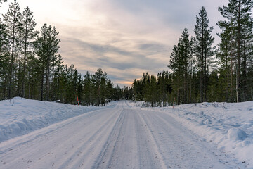 Fototapeta na wymiar Small winter road in the Swedish highlands