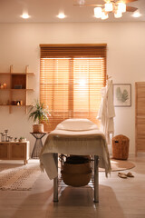 Stylish massage room interior in spa salon