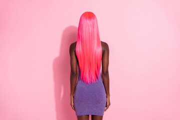 Photo portrait back view of african american woman with pink hair isolated on pastel pink colored...