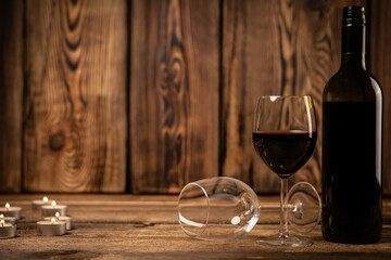 Red wine glasses and bottle red wine on old wooden background. 