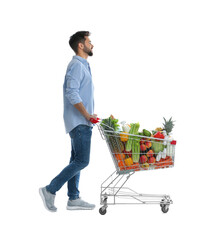 Young man with shopping cart full of groceries on white background © New Africa