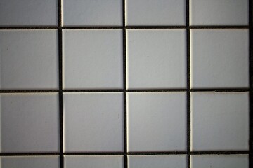 Naklejka premium evocative image of white and square tile wall texture 