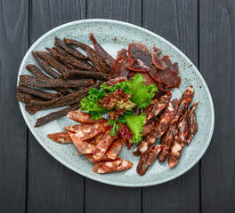 Traditional dry-cured sausage and jerky on a plate