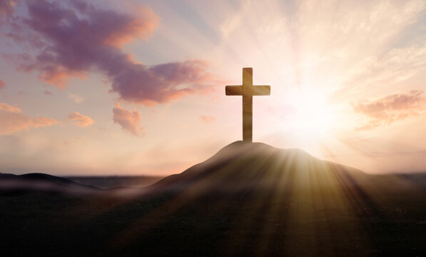 Christian cross on hill outdoors at sunrise. Resurrection of Jesus