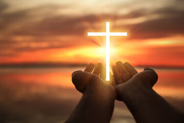 Woman and cross silhouette outdoors, closeup view. Belief in Jesus Christ