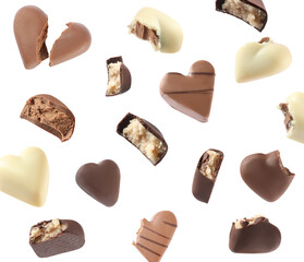 Delicious heart shaped chocolate candies falling on white background