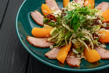 Fresh salad with grilled meat, caramelized peach and vegetables