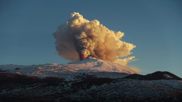 time lapse volcanic eruption in Sicily from Etna Volcano  north-east crater, the raising of a column of smoke accompanied by explosions of lava - 16 february 2021