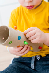 Match a color. Home made game from paper towel core. Insert correct color pin to assigned hole....
