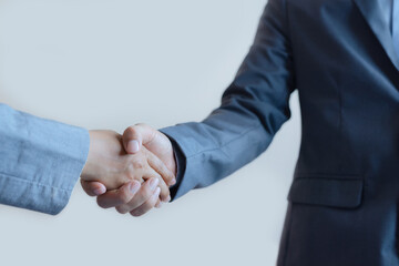 business man and business woman shaking hands for success deal a partnership together. friendship hand shake greeting.