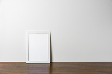 White wooden Photo or poster frame mock up on table. Minimal