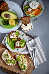 Sandwiches with soft cheese, avocado and cucumber. Breakfast is on the table. Healthy food. Toast and spread on it. Avocado sandwich stilllife. Healthy food. Toast.