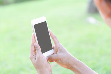 Closeup woman hand playing smartphone mobile with relaxing feelling, selective focus