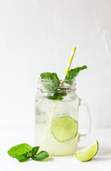 Summer drink on a white background on a glass with colorful straw