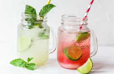 Summer drink on a white background on a glass with colorful straw