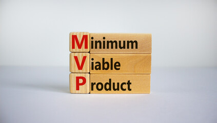 MVP, minimum viable product symbol. Wooden cubes and blocks with words MVP, minimum viable product. Beautiful white background. Business and MVP, minimum viable product concept, copy space.