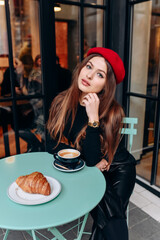 Girl drinking coffee in the cafe.