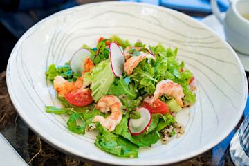 Close up  healthy delicious Mediterranean salad with seafood in street cafe	
