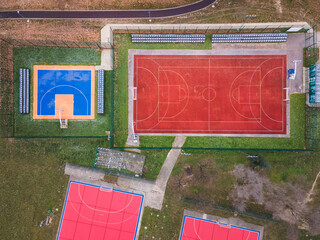 Colorful basketball, volleyball and soccer grounds. A red ,orange and blue colored outdoor sports...