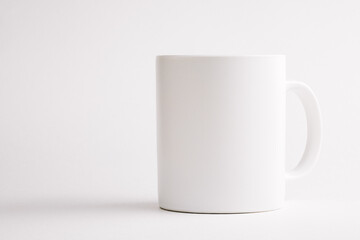 White ceramic cup on white background.