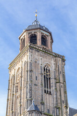 Fototapeta na wymiar Closeup of the ancient tower of the great church in the medieval centre of Deventer in Overijssel in the Netherlands