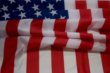 Fototapeta na wymiar USA flag on marble background, top view, place for your text. American flag lying on a marble slab. Place for your inscriptions. National holiday concept