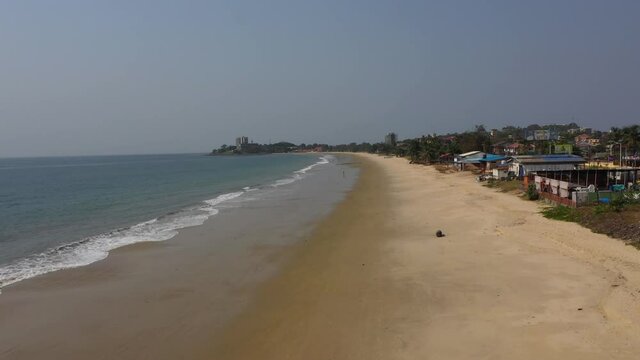 Aerial along ocean waves Lumley Beach Freetown. West Africa suffers with extreme poverty. Tropical climate, environment from savanna to rainforests. Beaches are mostly polluted with trash and sewage.