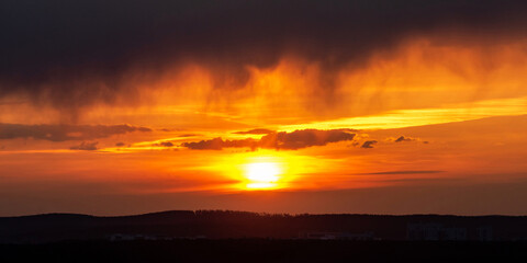 Dawn clouds over the metropolis of early winter sunset
