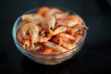 shrimp in a glass bowl on a black background