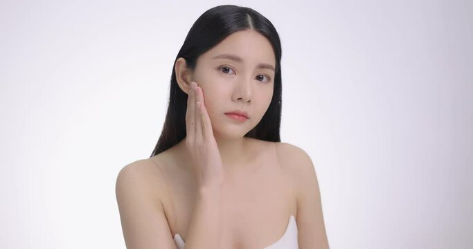 Beautiful Young Asian Woman Touching Her Face Softly. Feeling Worry About Face Skin Care Problem On Cheek.